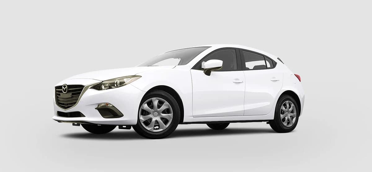 White Mazda hatchback before any vehicle wrap, plain factory finish