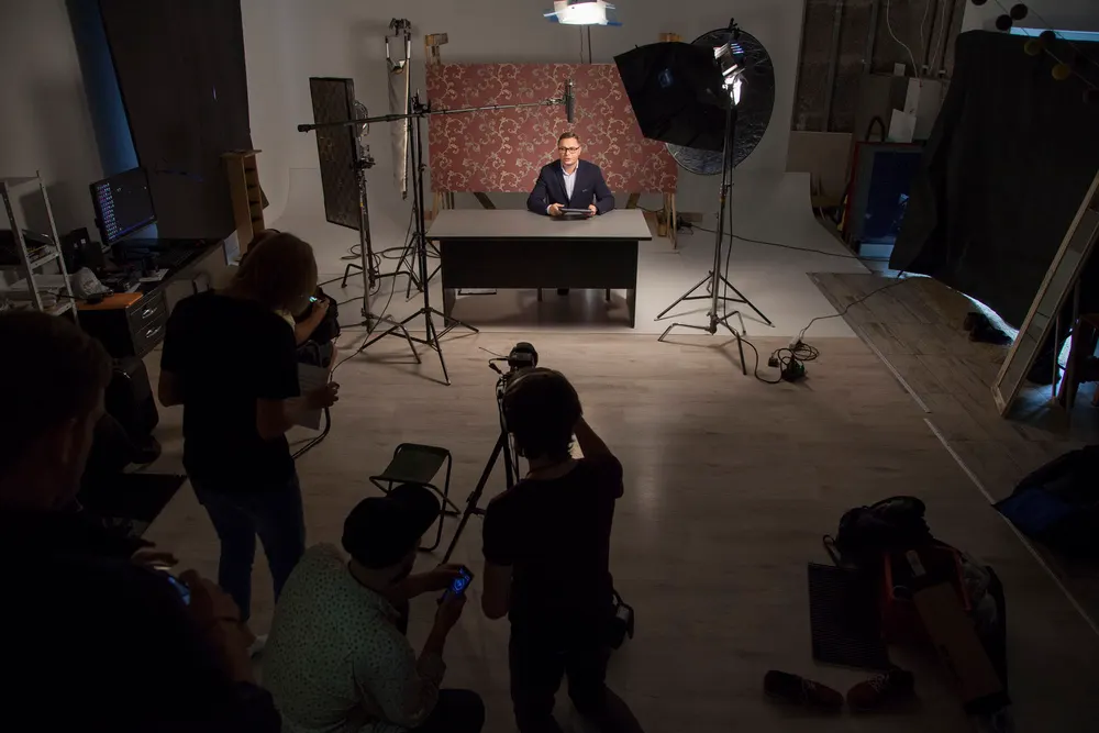 Overhead view of an on-camera interview setup with patterned backdrop