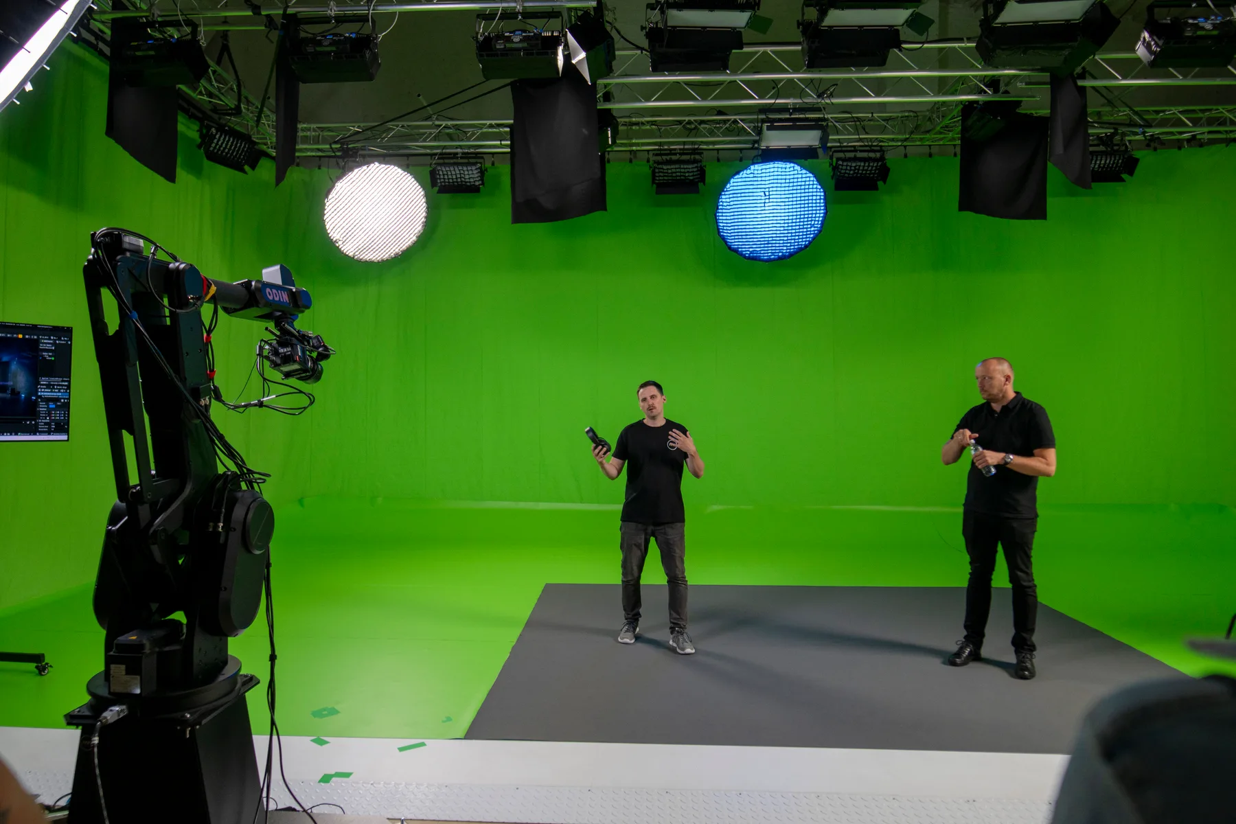 Robotic motion-control camera and presenter on a chromakey stage during a large-scale virtual production